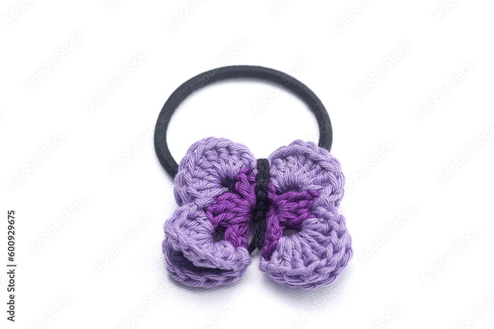 Fototapeta premium Crochet hair clips in the shape of a violet flower