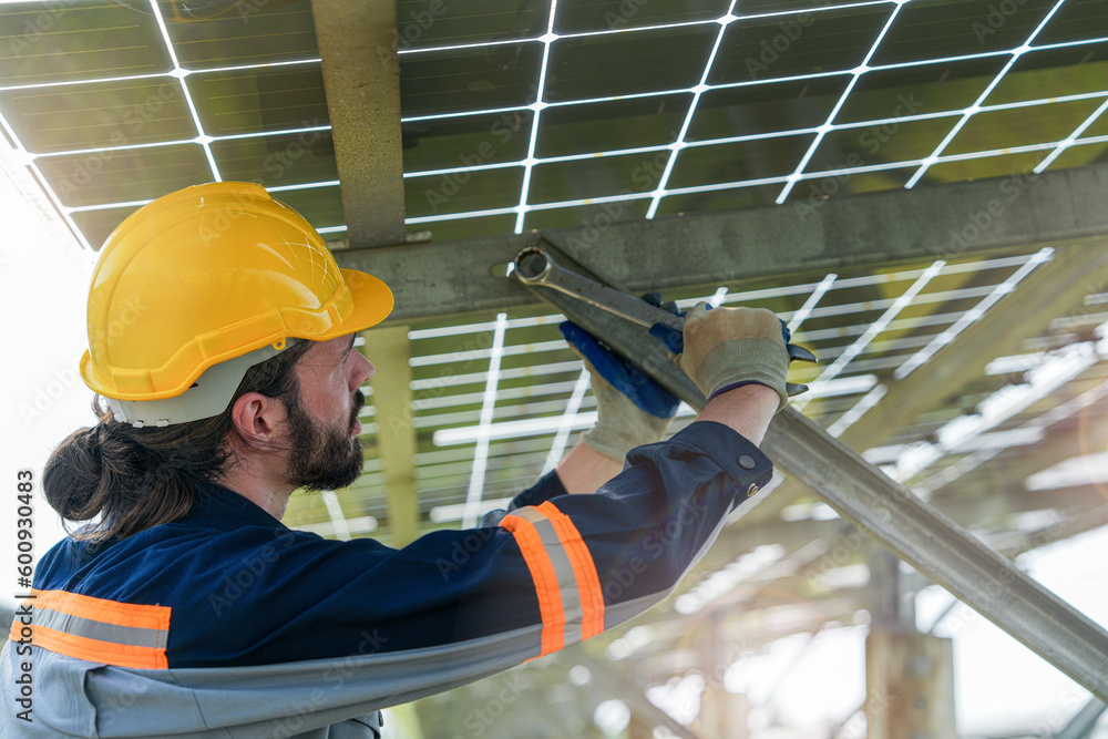 Factory engineer man checking and repairing solar panel construction ...