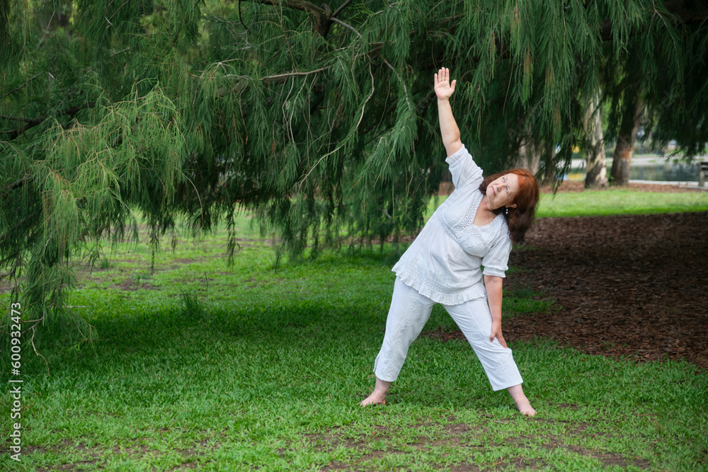 Senior Hispanic woman in white clothes exercising outdoors in a park. Concepts: wellness, vitality, active and healthy lifestyle. Senior Hispanic woman in white clothes exercising outdoors in a park. Concepts: wellness, vitality, active and healthy lifestyle.
