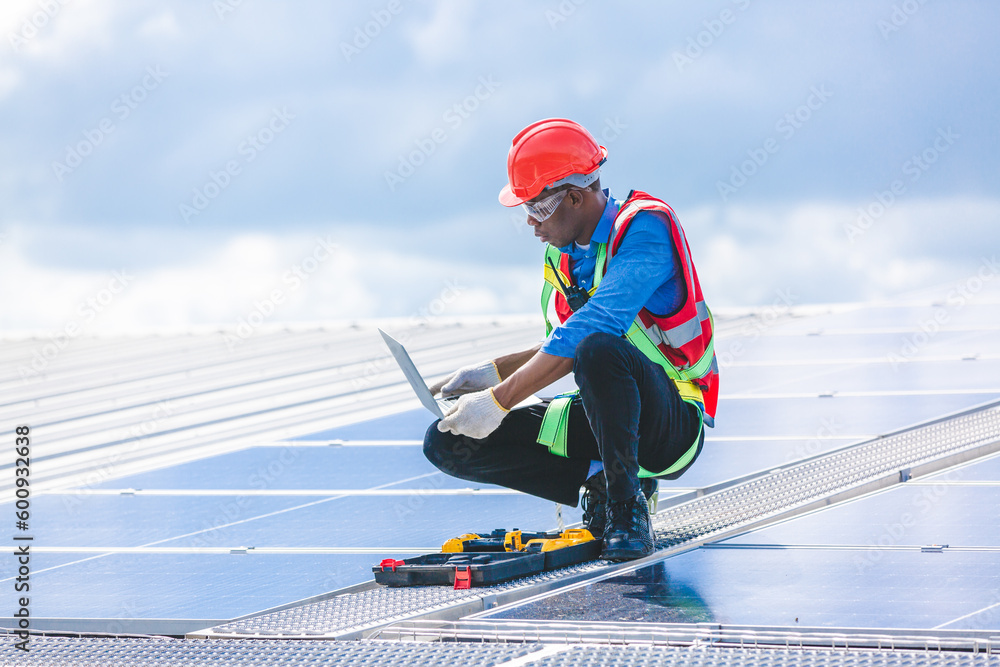 Professional worker cleaning solar panels with brush and washing with water on roof structure of building factory. Technician using mop to clean the dirty and dust, green electricity energy technology Professional worker cleaning solar panels with brush and washing with water on roof structure of building factory. Technician using mop to clean the dirty and dust, green electricity energy technology