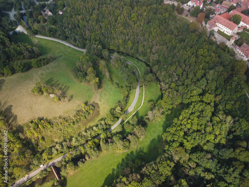 Road through the green forest, Aerial view of the road and medieval city