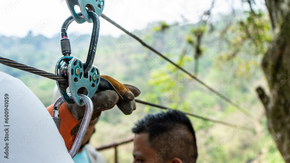 Tourist preparing harnesses to launch for a canopy in front of a waterfall in Matagalpa Nicaragua Tourist preparing harnesses to launch for a canopy in front of a waterfall in Matagalpa Nicaragua