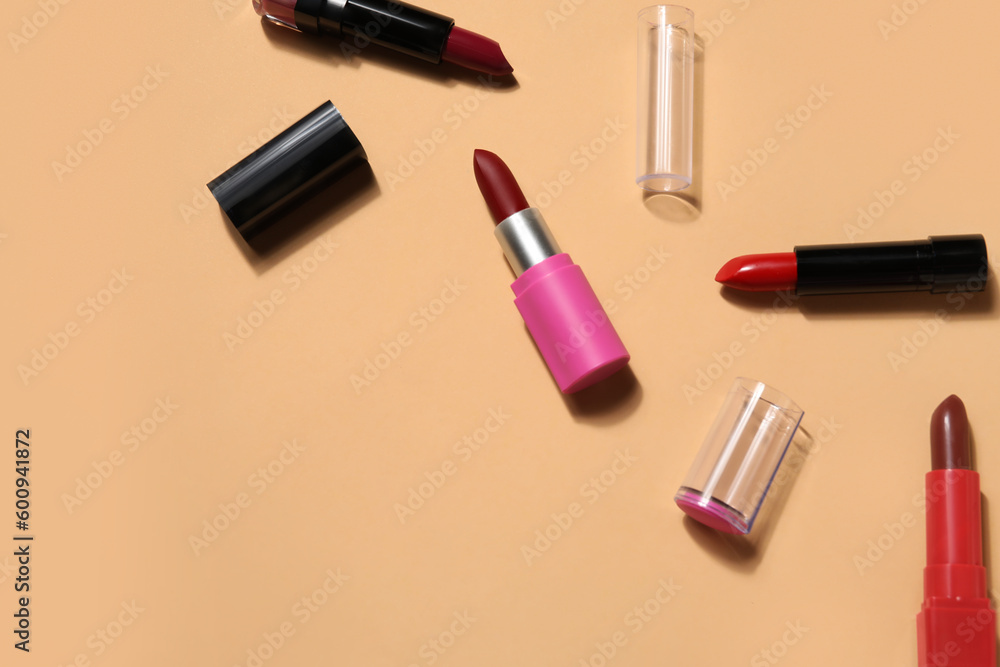 Obraz premium Different lipsticks on beige background