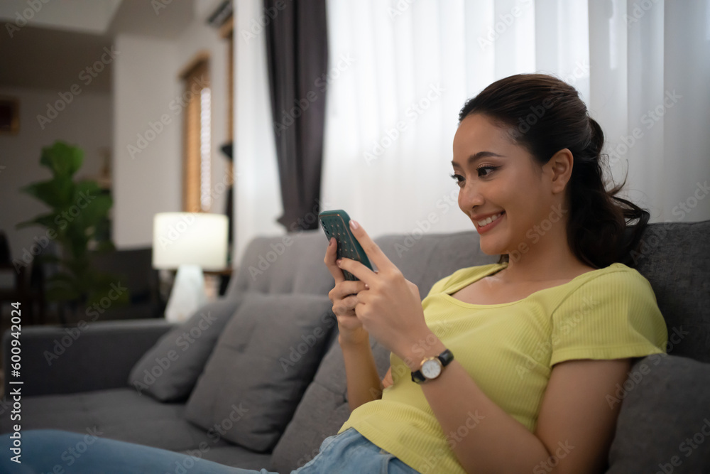 Woman using smart phone and Browsing Internet at home Woman using smart phone and Browsing Internet at home