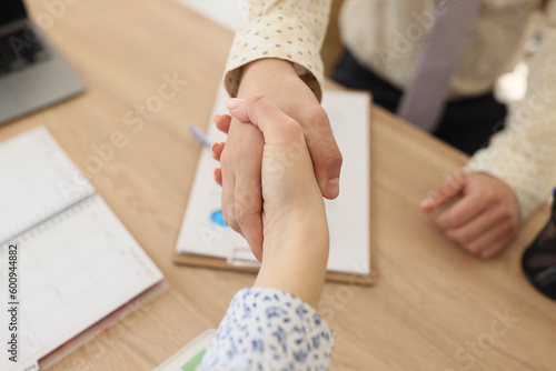 Female and male shaking hands in office