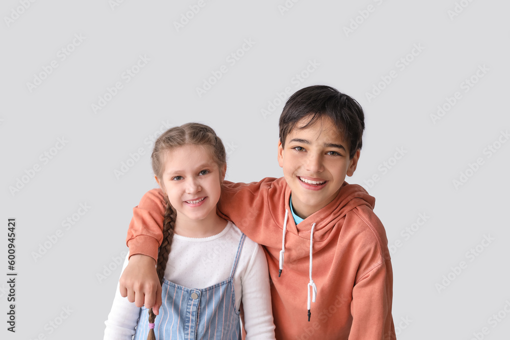 Little children hugging on light background Little children hugging on light background