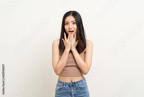Excited young asian woman shout out loud wow hands on mouth announcement isolated white background. Emotional Happy shocked face female wow promotion advertising concept.