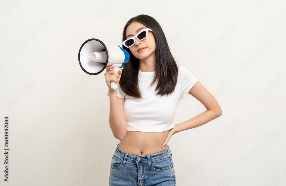 Shout out loud with megaphone. Young beautiful asian woman announces with a voice about promotions and advertisements for products at a discounted price. Standing on isolated white background. Shout out loud with megaphone. Young beautiful asian woman announces with a voice about promotions and advertisements for products at a discounted price. Standing on isolated white background.