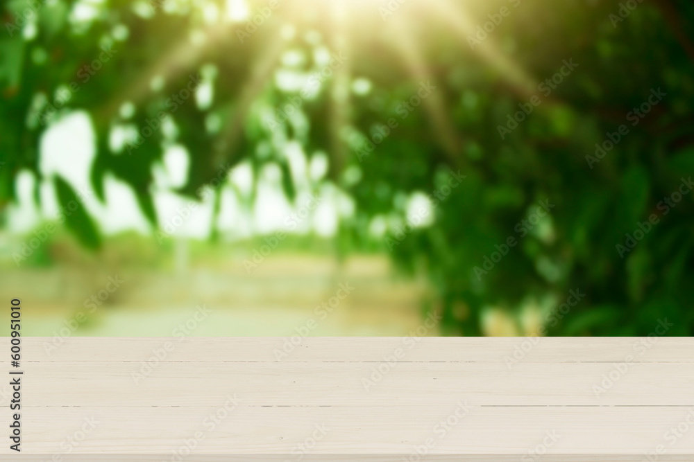 Wooden table top with natural green blurred background or various leaves, fresh bright sunlight, product empty concept. Wooden table top with natural green blurred background or various leaves, fresh bright sunlight, product empty concept.