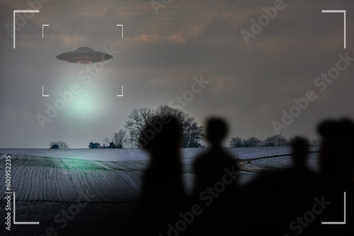 UFO, alien and camcorder on a camera display to record a flying saucer in the sky over area 51. Viewfinder, sighting and conspiracy with a spaceship on a recording device screen outdoor in nature photo