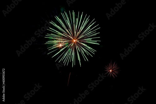Bright rays of fire on black background. Festive fireworks against of night sky in honor of Victory Day.