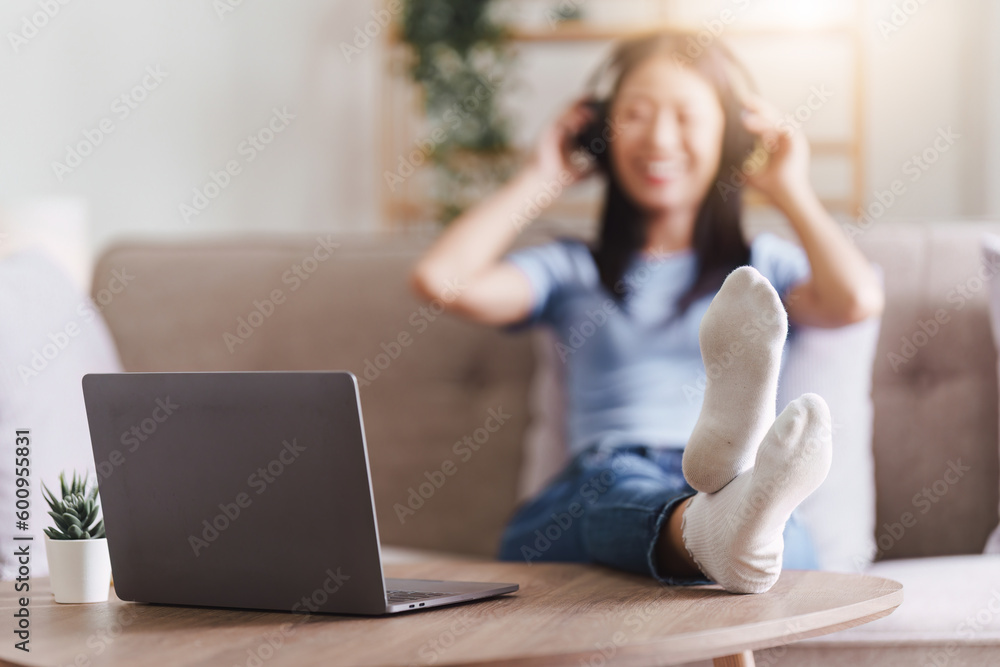 Attractive Asian woman resting comfortable living room and using laptop computer, Relax, Sofa, Lifestyle Attractive Asian woman resting comfortable living room and using laptop computer, Relax, Sofa, Lifestyle