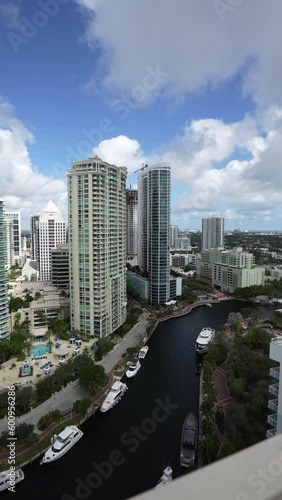 epic vertical timelapse of downtown fort lauderdale river front area with boats clouds and buildings during the day