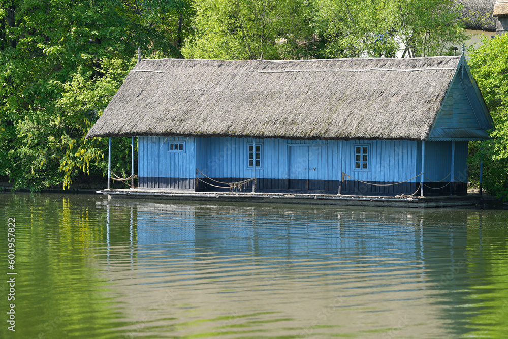 the old wooden house with a reed roof located on the water's edge. the fisherman's house.