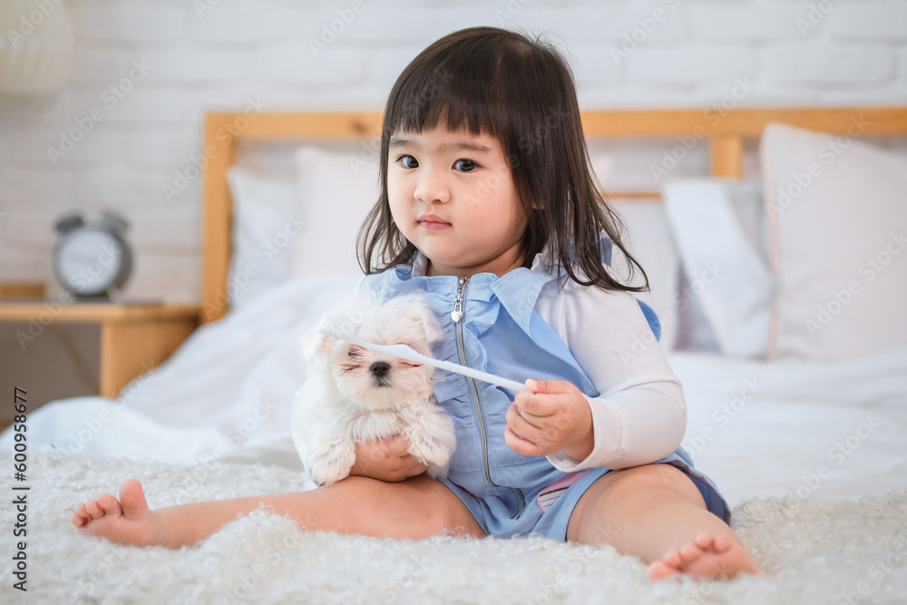 It was a beautiful moment of pure love and joy as the little girl and her furry friend sat together on the bed lost in their own world of bliss. It was a beautiful moment of pure love and joy as the little girl and her furry friend sat together on the bed lost in their own world of bliss.