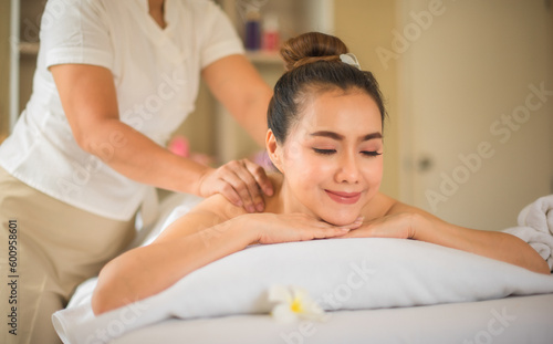 With her eyes closed and a faint smile on her lips the asian girl seemed to be savoring every moment of her spa experience with professional masseuse.
