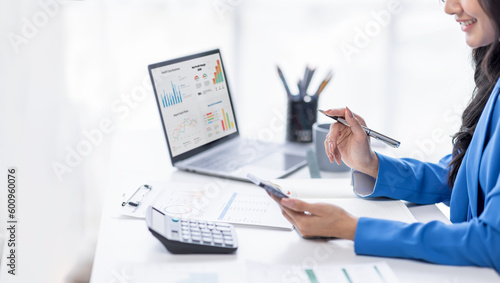 Financial Businesswomen analyze the graph of the company's performance to create profits and growth, Market research reports and income statistics, Financial and Accounting concept. 