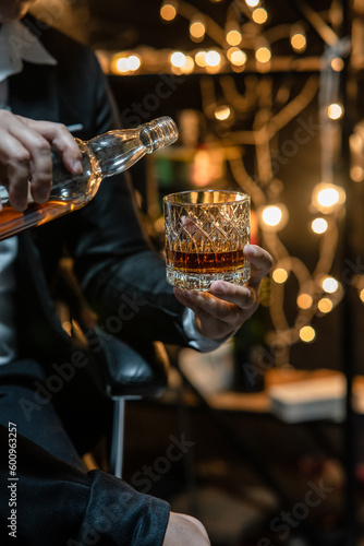 Barman pouring whiskey whiskey glass beautiful night