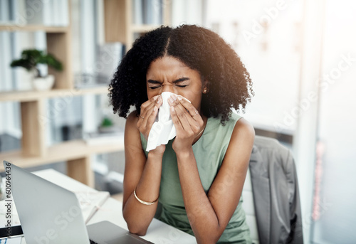 Blowing nose, tissue or sick black woman in office with virus or worker with allergies, problems or illness. Person sneezing or African girl employee with toilet paper, allergy flu or fever disease photo