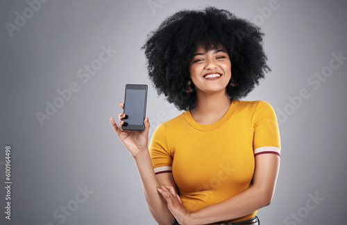 Technology, portrait of black woman with smartphone screen and in background. Communication or social media, networking and happy African female with cellphone for advertisement in studio backdrop