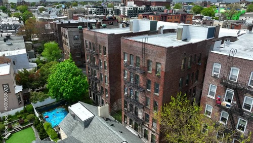 Red brick apartment building in NYC with fire escape stairs for emergencies. Aerial push in. photo