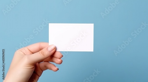 Woman’s hand showing blank business card on blue background. Generative AI.
