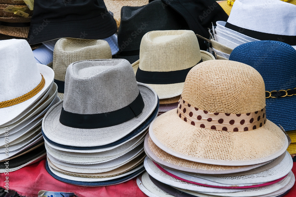 Summer straw hats on display in an open air shop