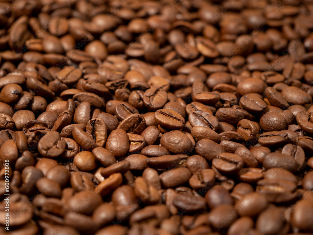 Background from roasted coffee beans. Scattered coffee beans. Background from roasted coffee beans. Scattered coffee beans.