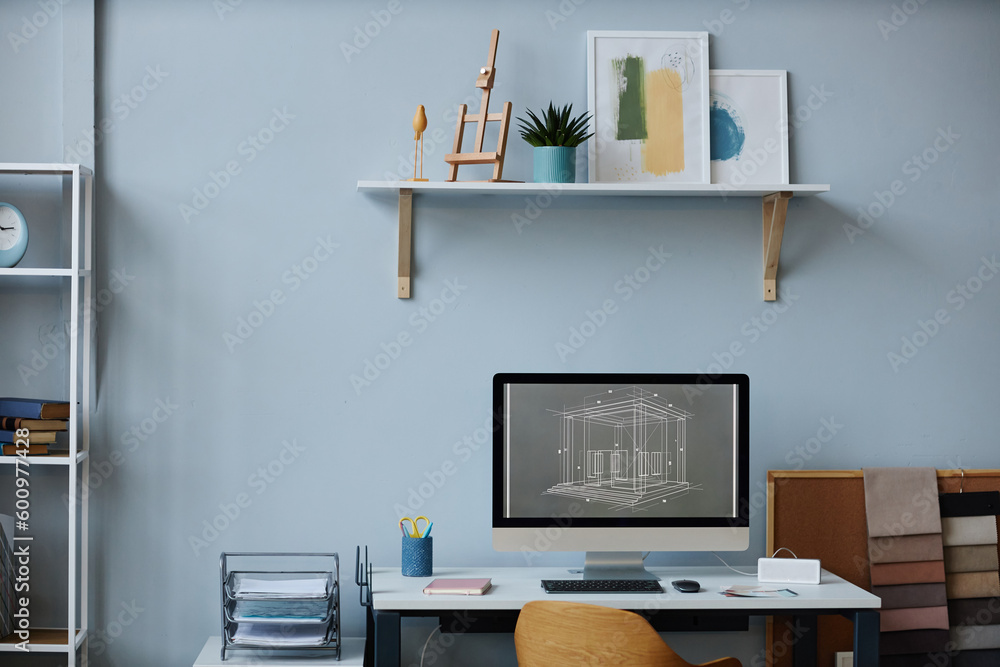 Modern workplace of designer with computer monitor on table in office Modern workplace of designer with computer monitor on table in office