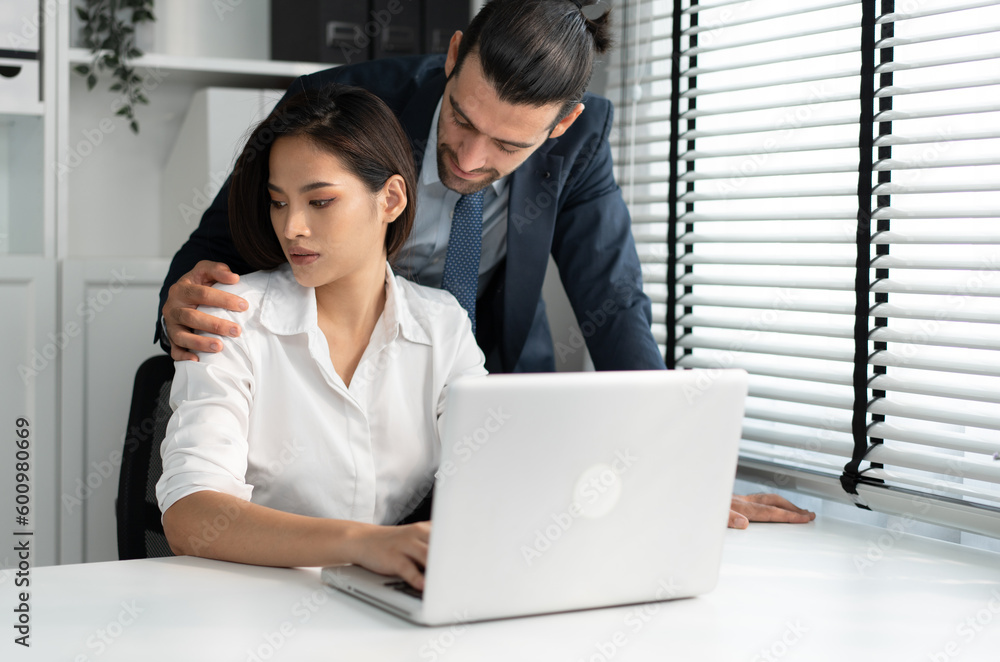 Sexual harassment at workplace concept. Attractive Asia woman being