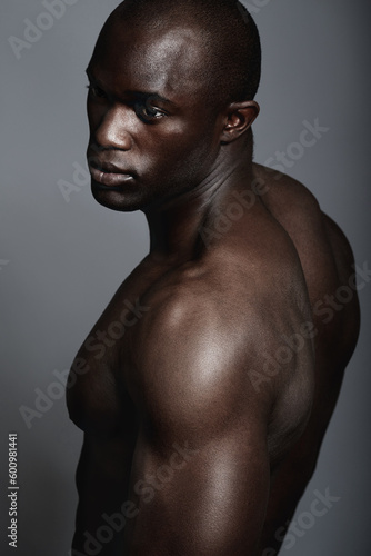 Art, aesthetic and beauty, black man on dark background with muscle and fitness, strong and serious body builder. Health, wellness and African bodybuilder or male model isolated on studio backdrop.