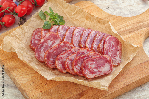 Sliced salami sausages over board