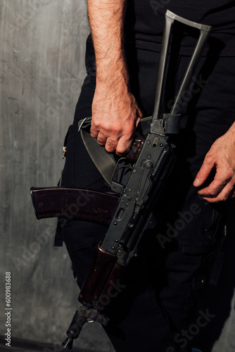 a man holds a military assault rifle in his hands