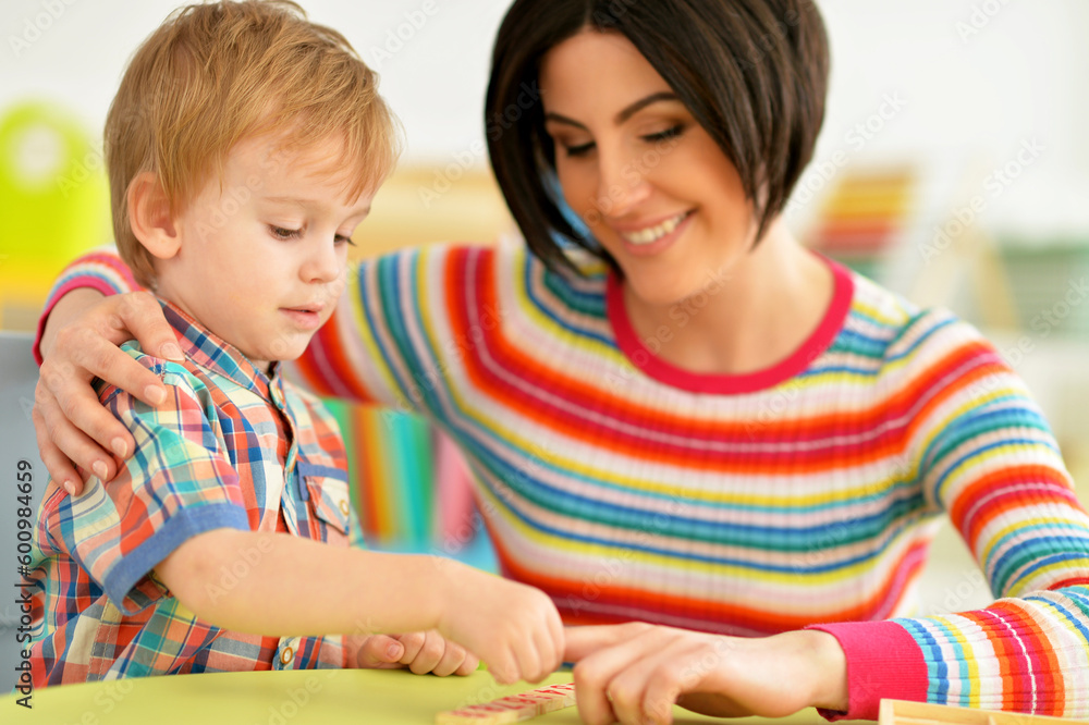 Young mother and cute little son playing