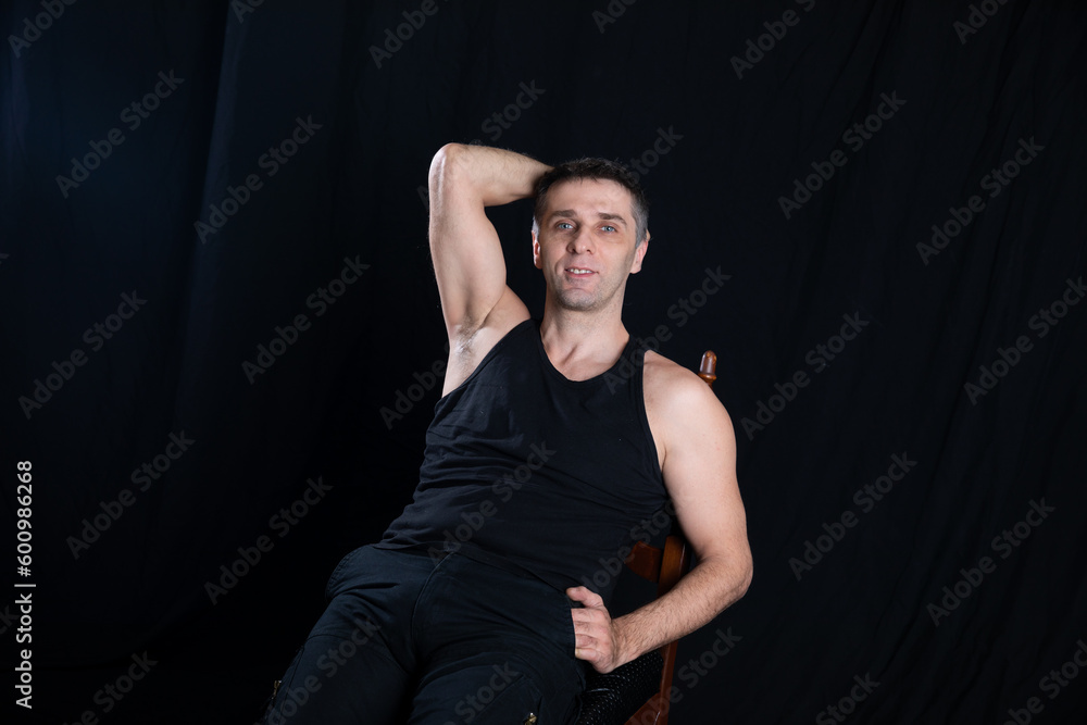 a man in dark clothes sits in a dark room a man in dark clothes sits in a dark room