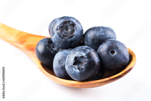 Fresh blueberries in wooden spoon