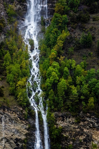 Drone shot of  waterfall in the forest  Aosta Valley  Italy