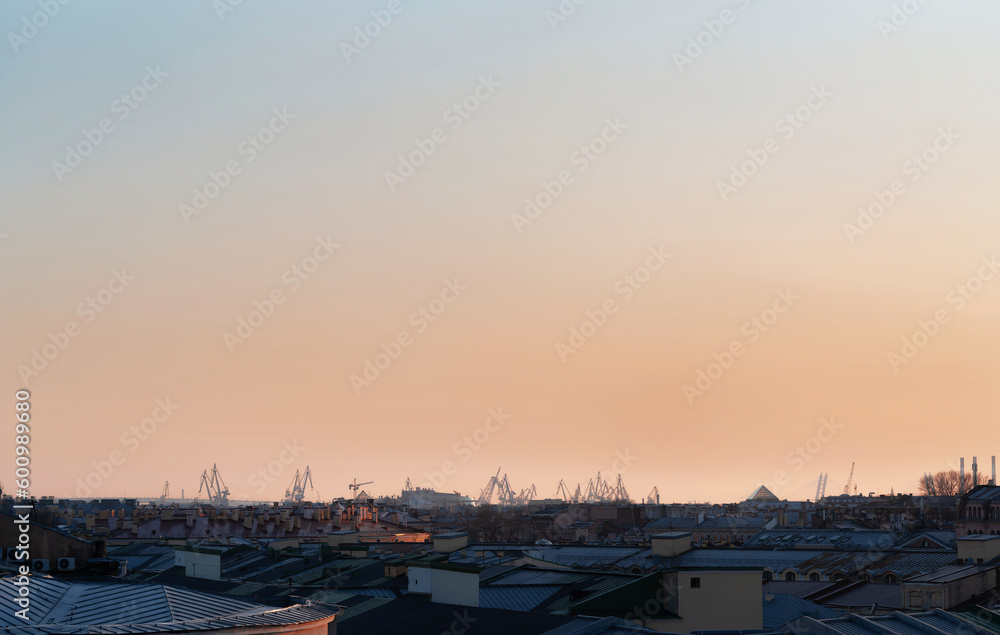 Panoramic view of the roofs, towers, domes of churches and cathedrals in sunset light on the spring evening. Saint-Petersburg, Russia. Travelling and tourism concept. Copy space.