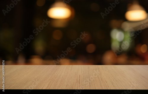 Empty wooden table in front of abstract blurred background of coffee shop . can be used for display or montage your products.Mock up for display of product