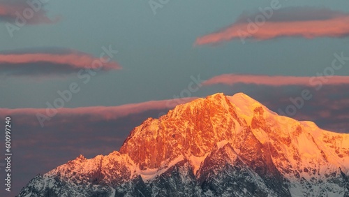 Fototapeta Naklejka Na Ścianę i Meble -  Sunrise on Mount Blanc, with orange light on the snow, Italy