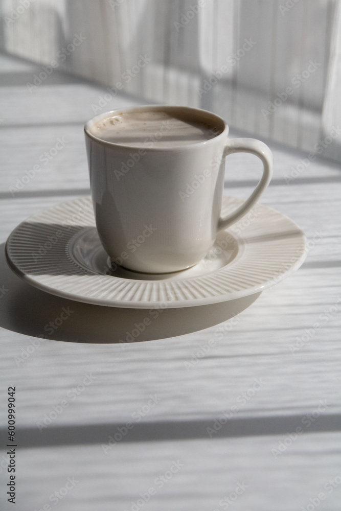 photo white cup with coffee on a saucer
