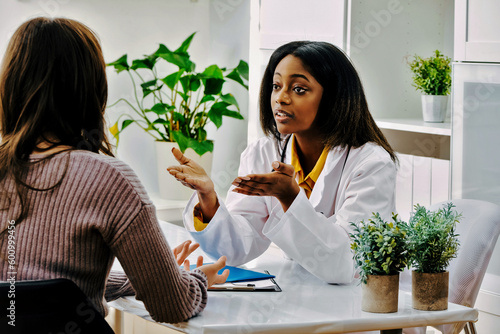 Female doctor explaining to young woman in surgery