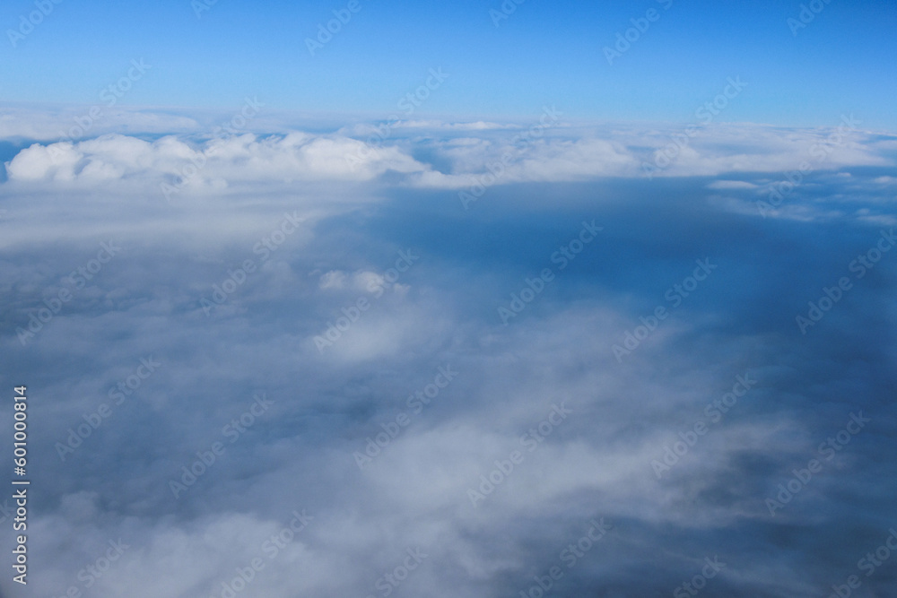 View through window of an aircraft during flight with gorgeous blue sky in background is breathtaking View through window of an aircraft during flight with gorgeous blue sky in background is breathtaking