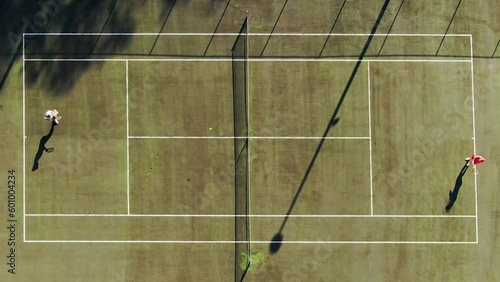 Top-down aerial shot of two women playing tennis. photo