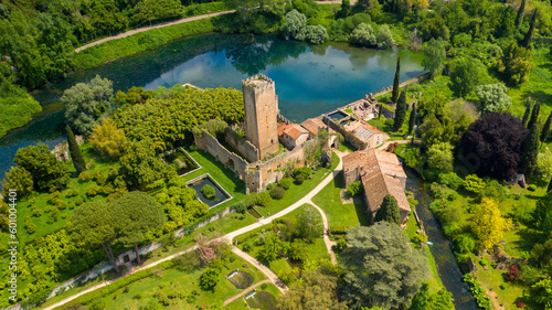 Photography Aerial view of the ruins of the castle and tower located in the garden of Ninfa, near Latina, Italy