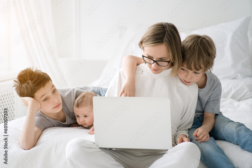 Work from home. Mother working with children and laptop computer at home. Quarantine and closed school during coronavirus outbreak. Work from home. Mother working with children and laptop computer at home. Quarantine and closed school during coronavirus outbreak.