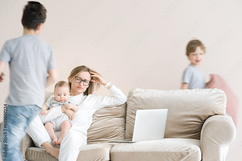 Work from home. Mother working with children and laptop computer at home. Quarantine and closed school during coronavirus outbreak. Work from home. Mother working with children and laptop computer at home. Quarantine and closed school during coronavirus outbreak.