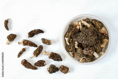spring mushrooms dried morels lie on a plate on a white background