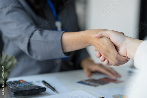 Young businesswoman, company worker shaking hands congratulating customer approved credit card and credit limit, benefit, insurance concept, loan, payment.