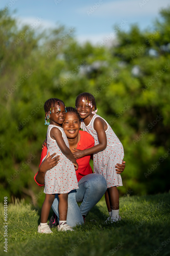 Two black-skinned sisters sunset with their mom Two black-skinned sisters sunset with their mom